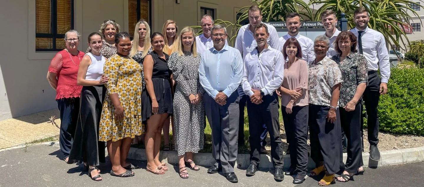 A group photograph outside the offices of Malan Lourens Viljoen Inc.